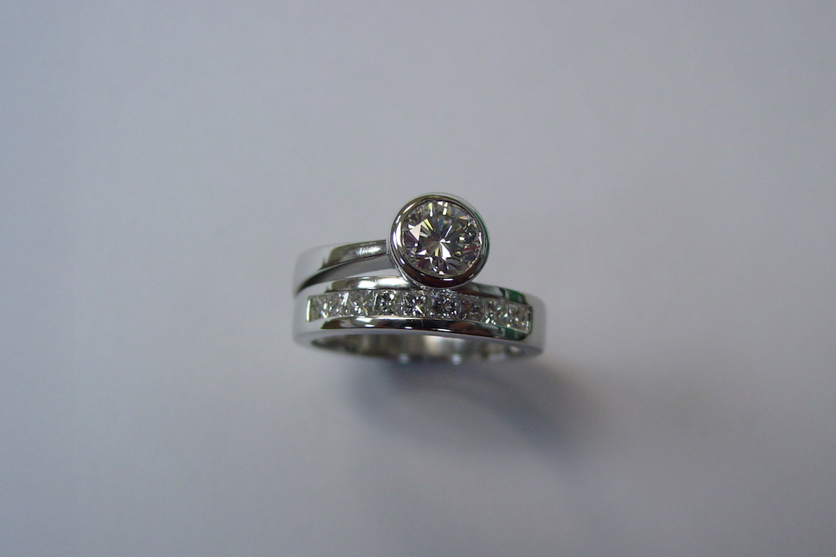 Bezel Set Diamond with a Channel Set White Gold Diamond Band