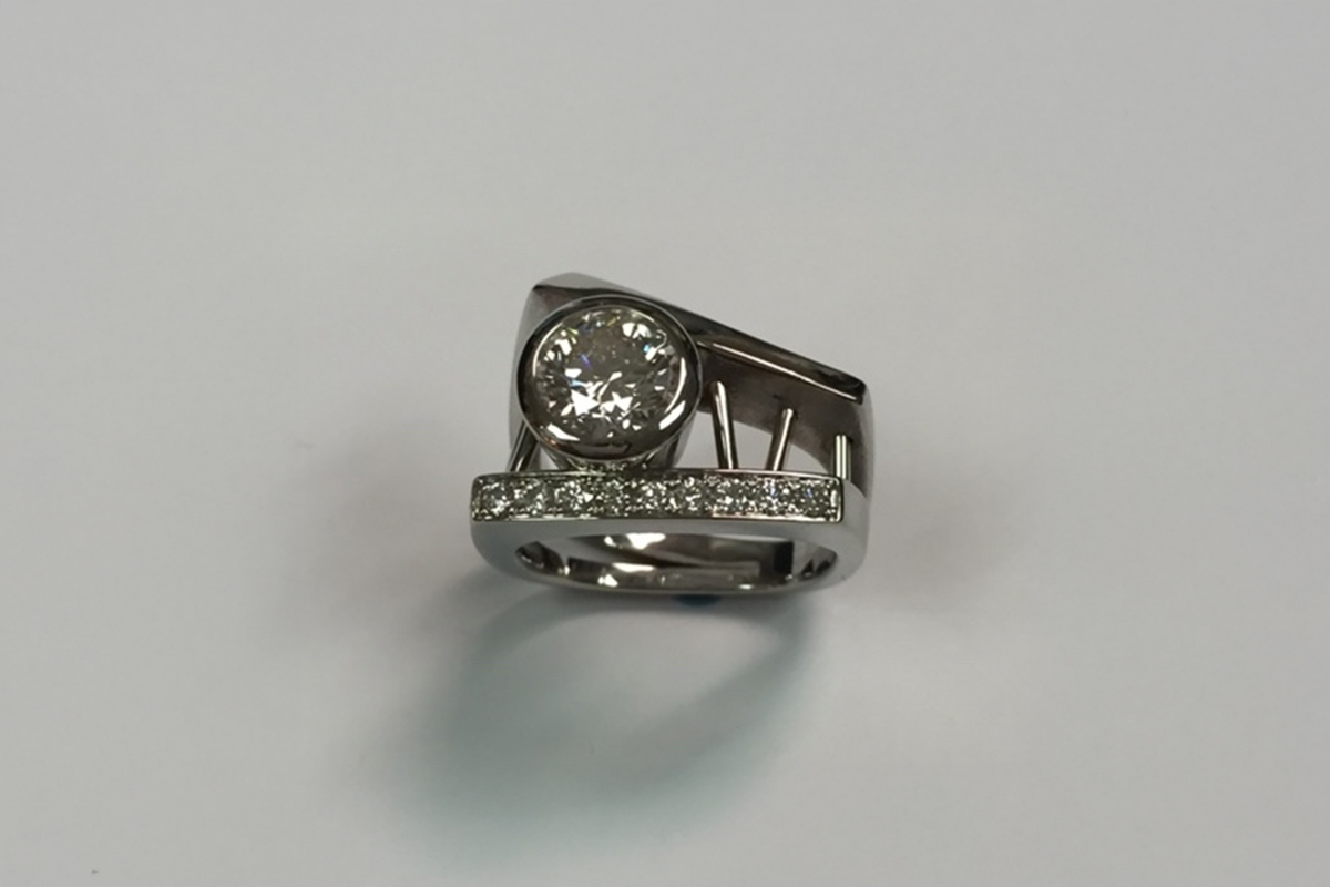 Bezel Set Round Diamond Ring in a White Gold Stacked Setting with Channel Set Diamonds