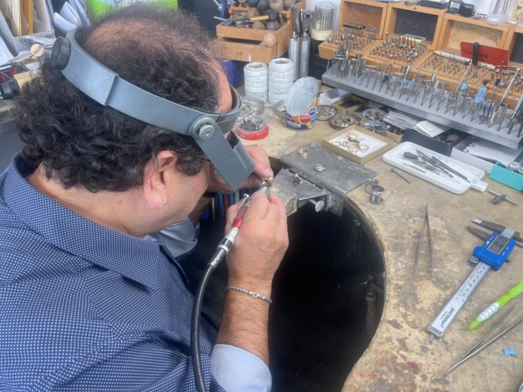 Goldsmith carefully crafting jewelry pieces