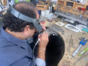 Goldsmith carefully crafting jewelry pieces