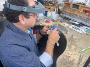 Goldsmith carefully examining a diamond piece