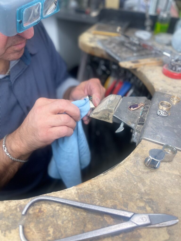 Goldsmith in Alberta crafting an engagement ring in his working station
