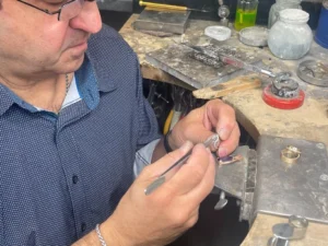 Jeweler handcrafting a custom ring in a workshop