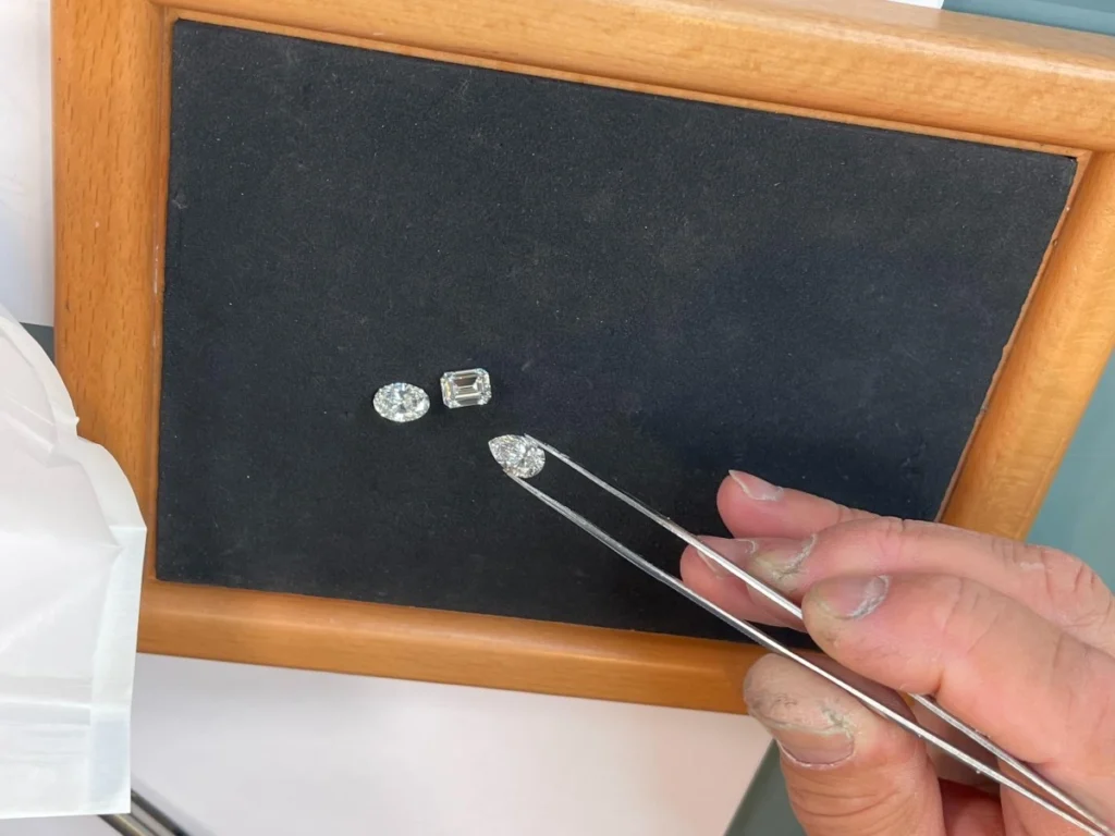 Jeweler doing gemstone sourcing with precision tweezers